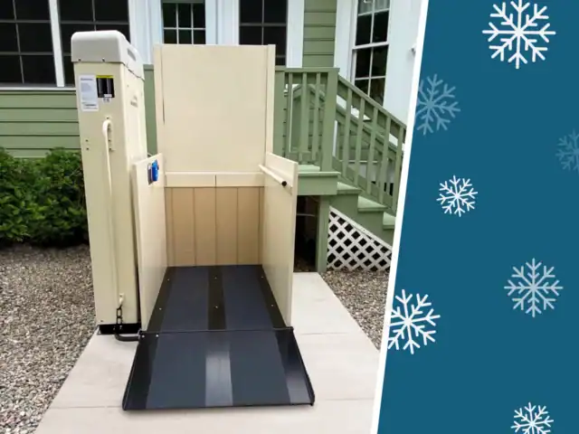 Outdoor vertical platform lift positioned by stairs outside a house, with a graphic of white snowflakes on a teal background beside the image.